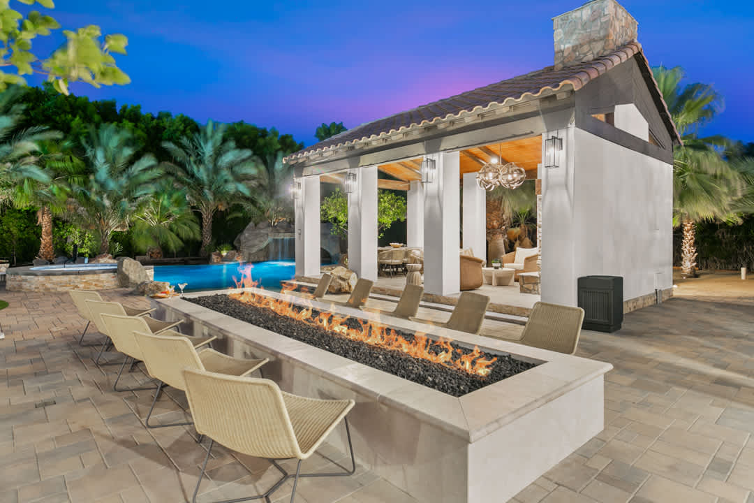 Poolside seating and firepit at twilight